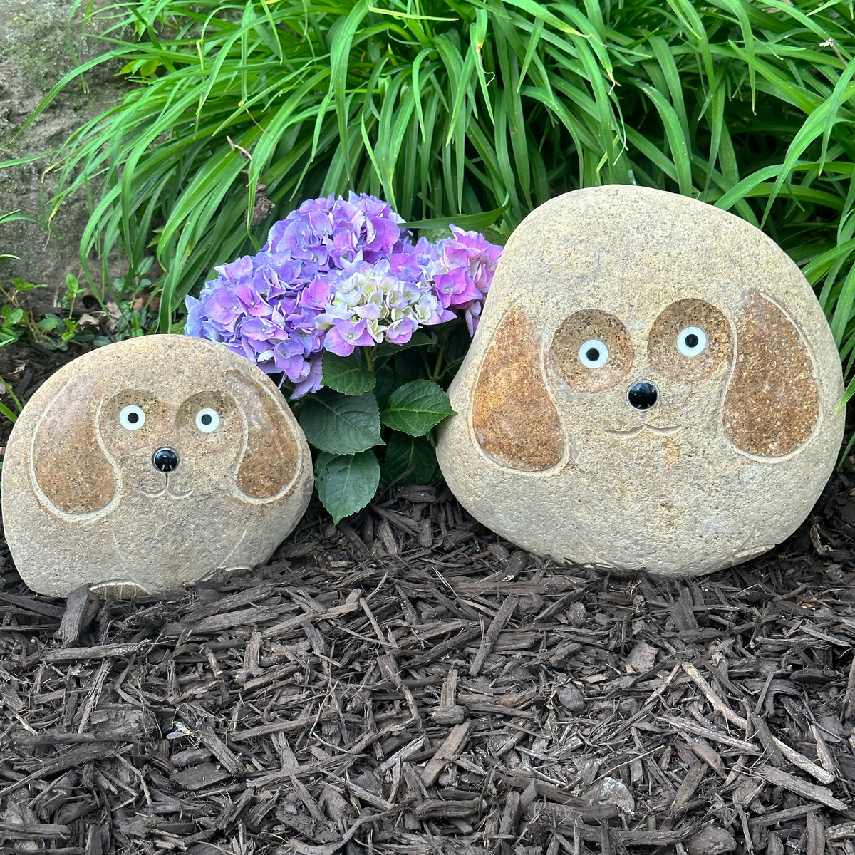 Hand-carved natural granite boulder stone dog sculptures in garden, 2-piece set.