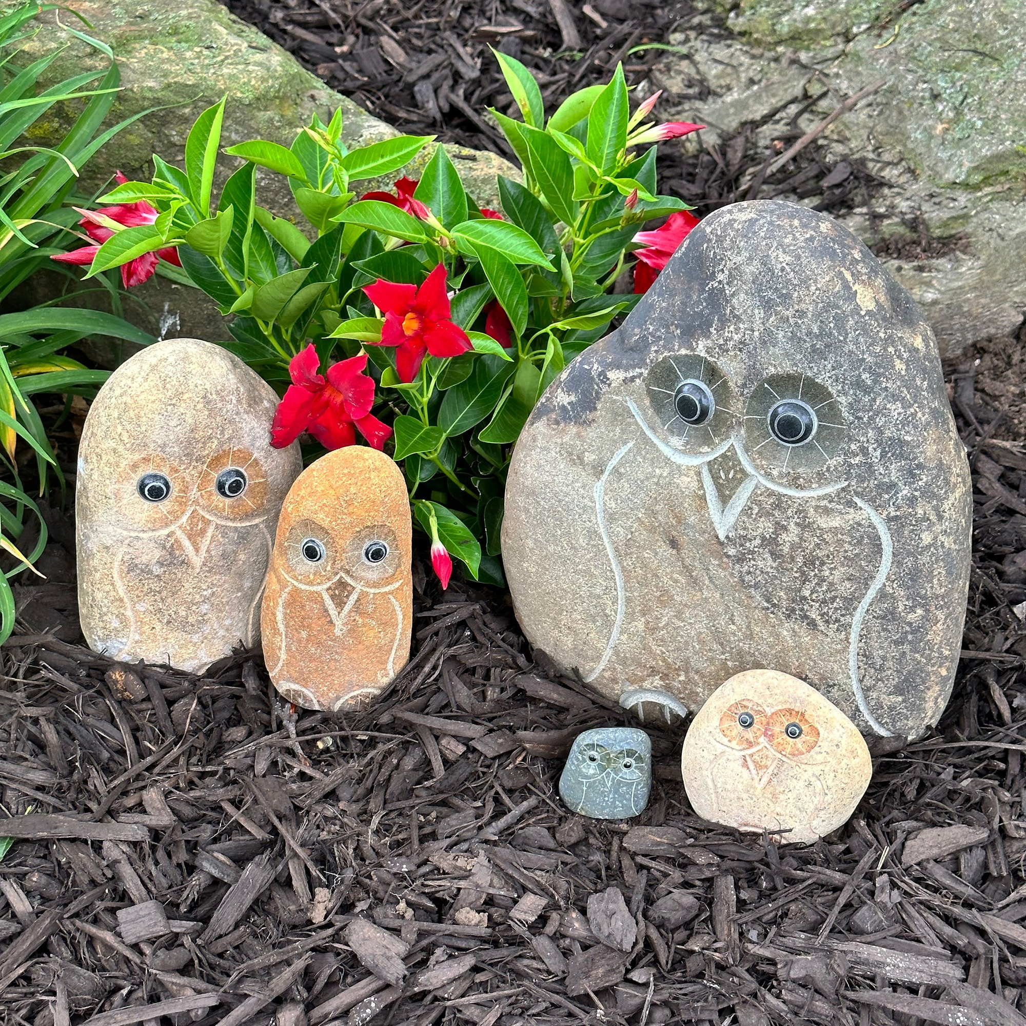 Hand-carved granite boulder stone owl family set, showcasing five unique sizes, perfect for garden or home decor.