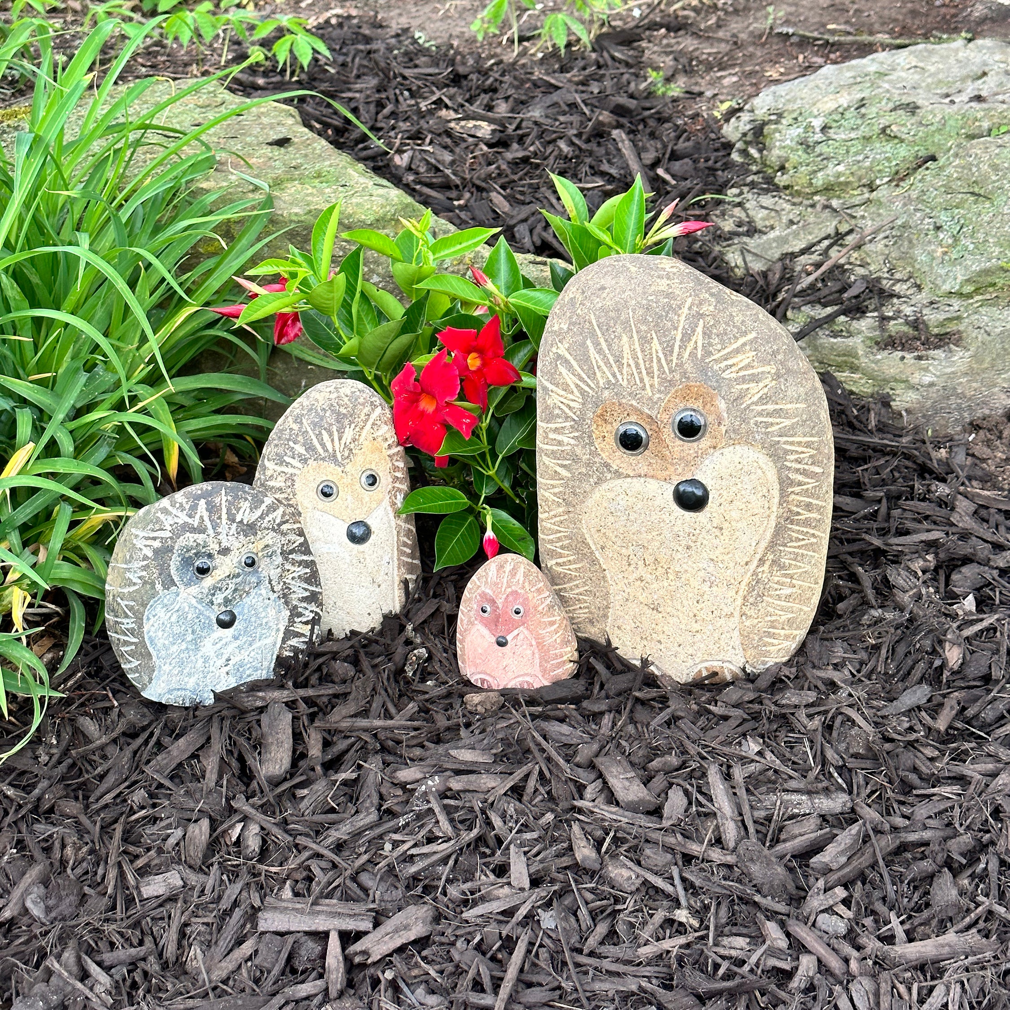 Hand-carved granite stone hedgehogs set in garden setting, showcasing unique details and various sizes.