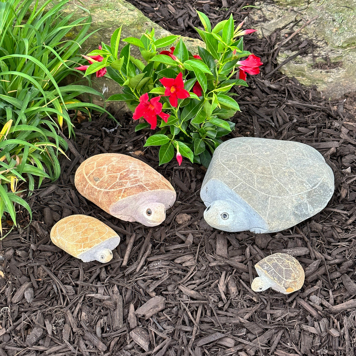 Hand-carved natural granite boulder stone turtles, 4-piece set in garden.