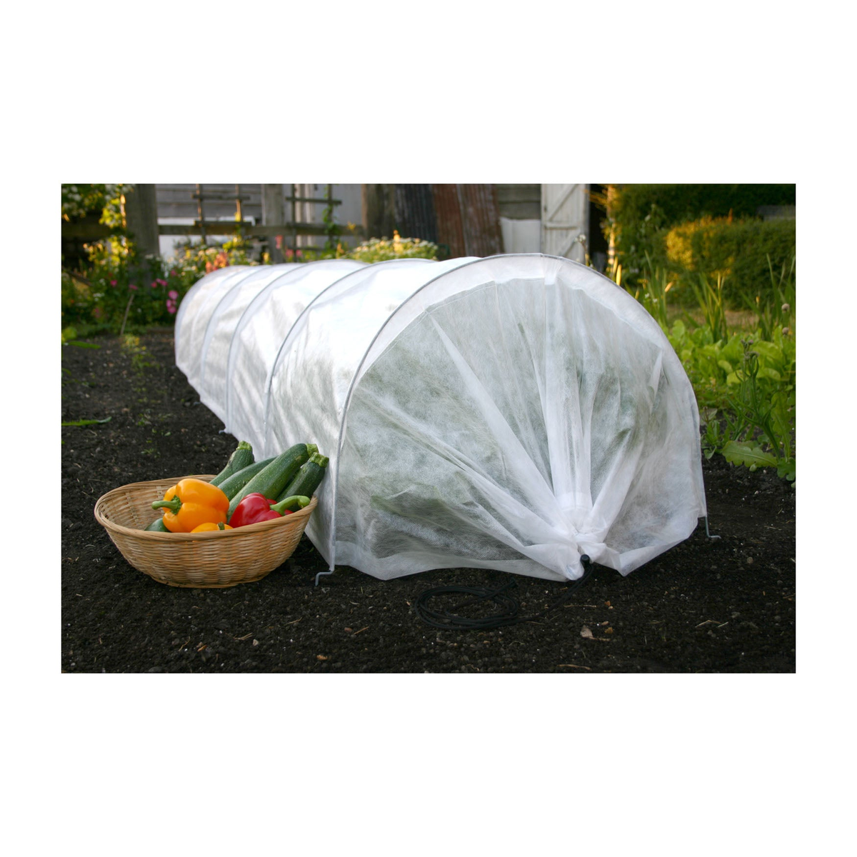 Giant Easy Fleece Garden Tunnel, 118&quot; providing plant protection and insulation in garden.