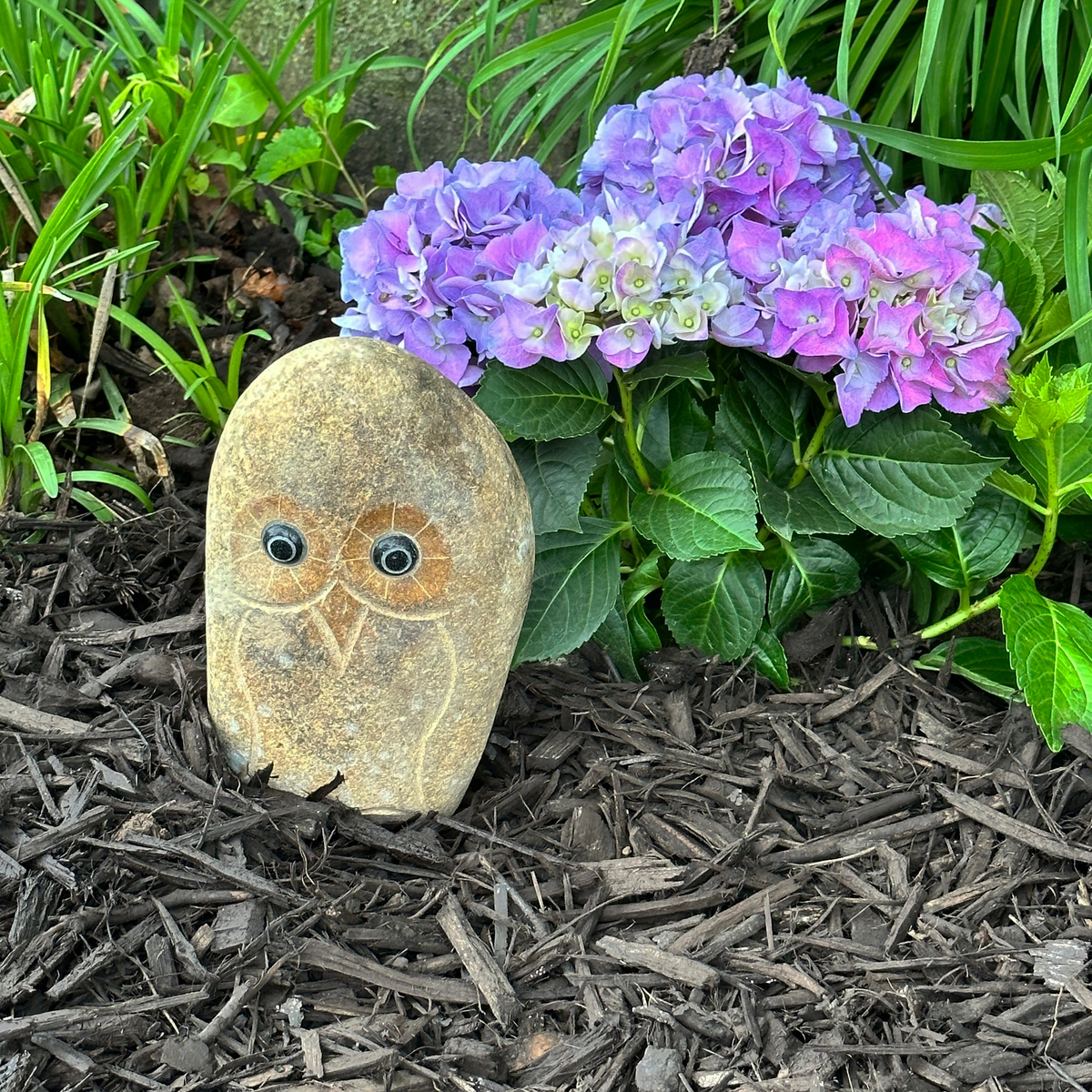 Hand carved natural granite 8&quot; boulder owl statue in garden setting.