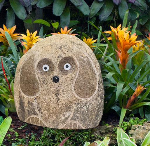 Hand carved natural granite 12" boulder stone dog in garden setting.