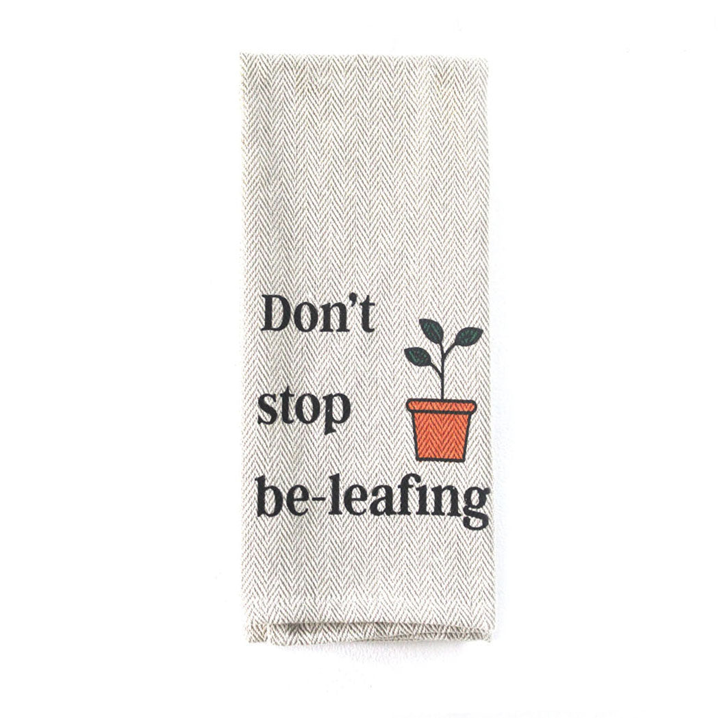 Kitchen tea towel with "Don't Stop Be-leafing" print, neutral khaki, 16x28 inches, eco-friendly cotton.