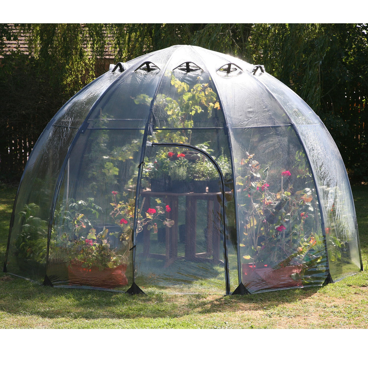 Large Sunbubble walk-in greenhouse with UV-stabilized PVC and fiberglass, featuring adjustable vents and zippered doorway, in a garden setting.