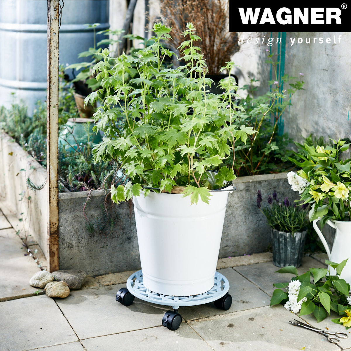 11.4&quot; smoke gray cast iron plant caddy with brakes, supporting a potted plant on patio.