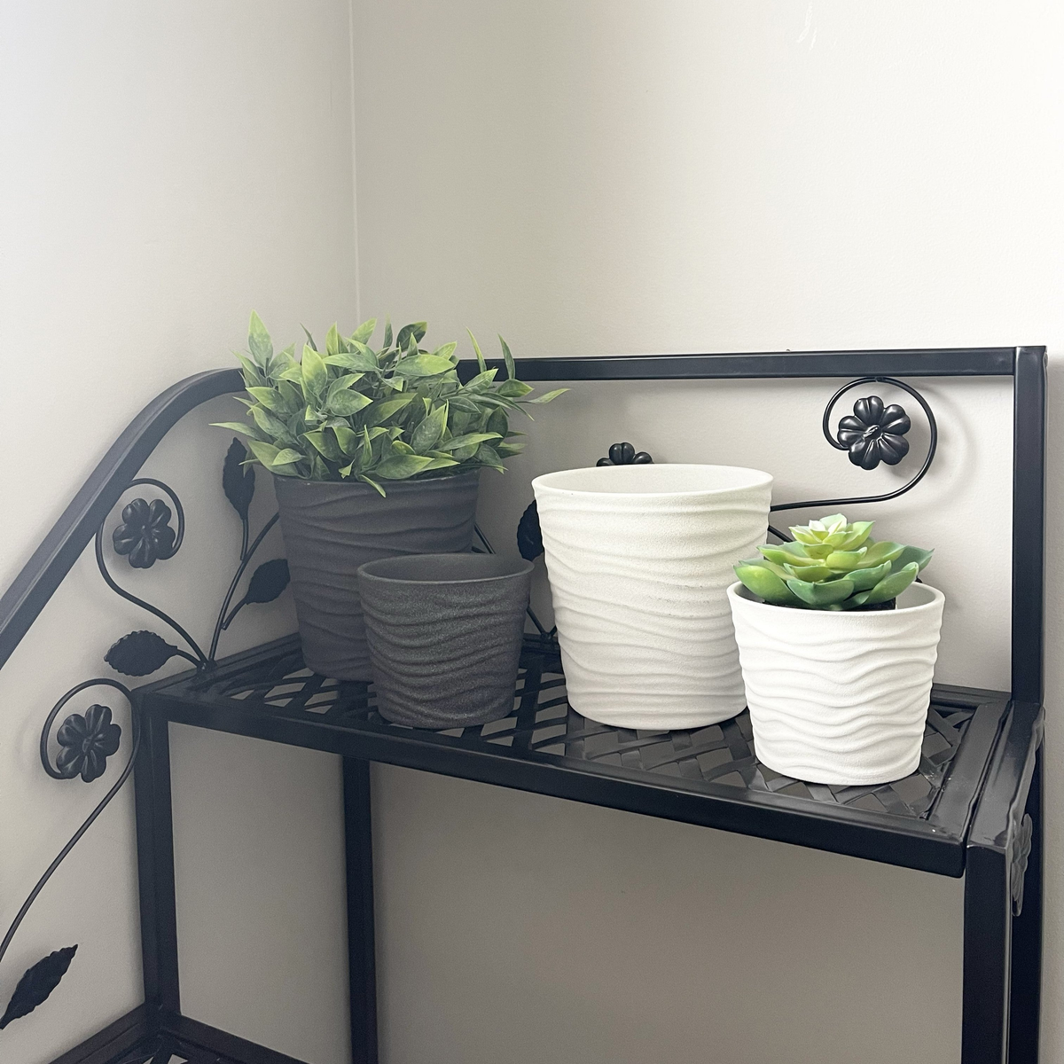 4-piece indoor ceramic plant pot set, white and anthracite, on decorative shelf.