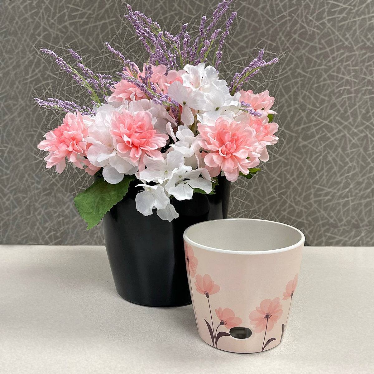 Self-watering plant pot set with 5&quot; pink flower design and 7&quot; black solid, made from eco-friendly bamboo fiber.