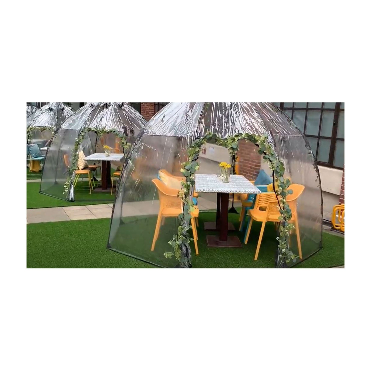 Walk-In Greenhouse with clear dome design and yellow chairs.