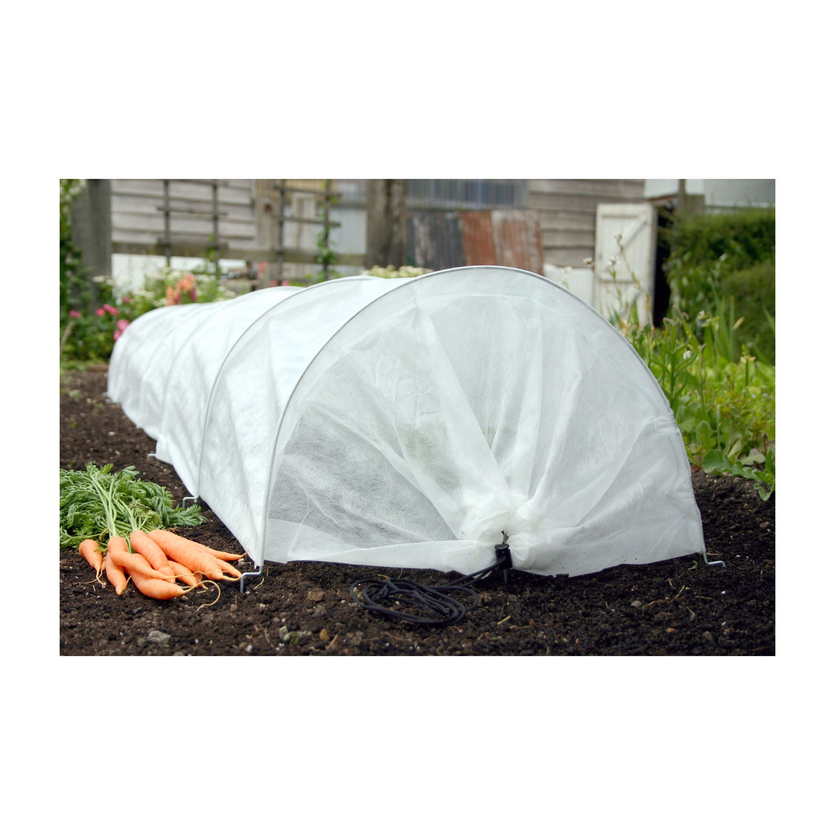 Easy Fleece Garden Tunnel 118&quot; providing plant protection and insulation in a garden setting.