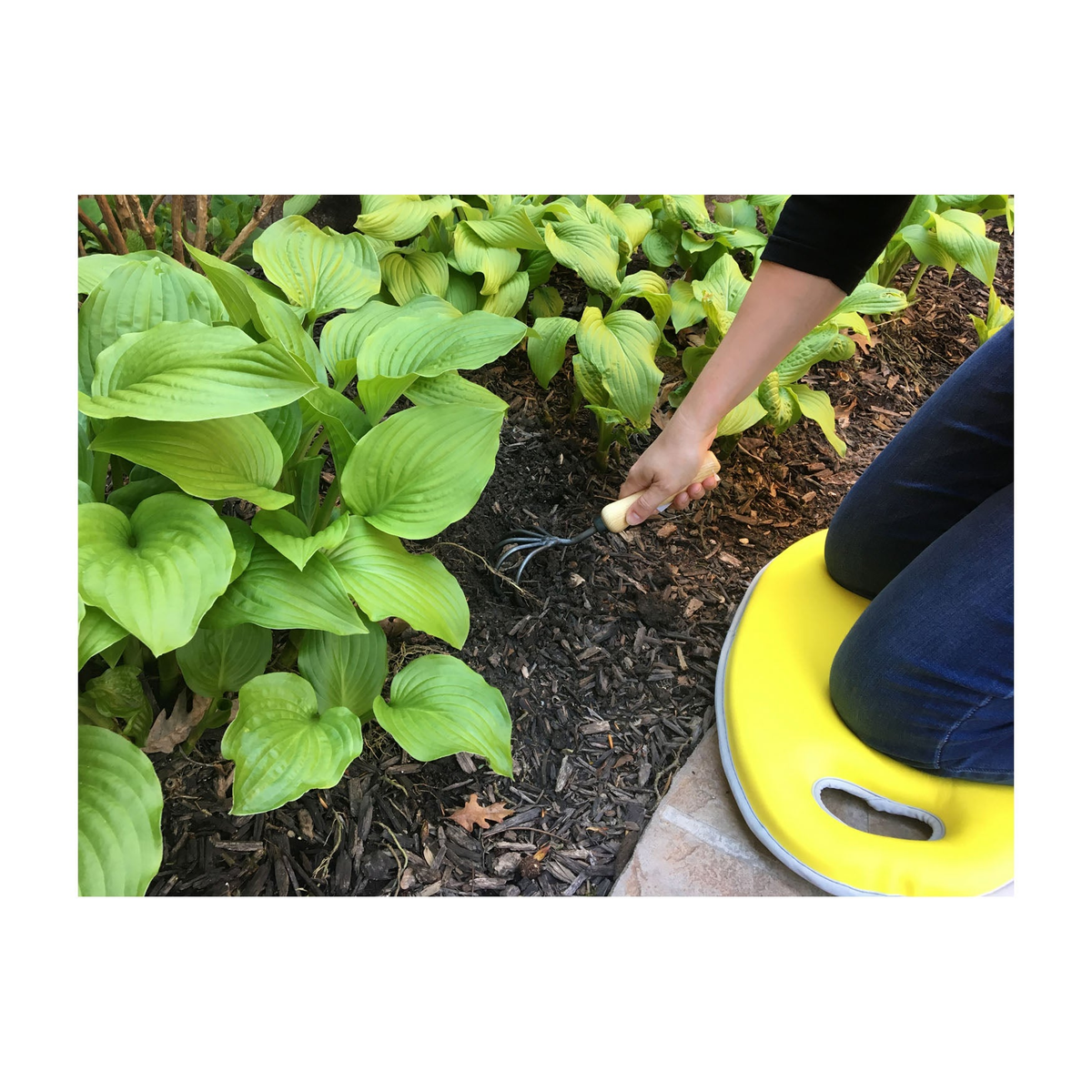 Yellow multipurpose memory foam kneeling cushion used for gardening, featuring a convenient handle and durable neoprene cover.