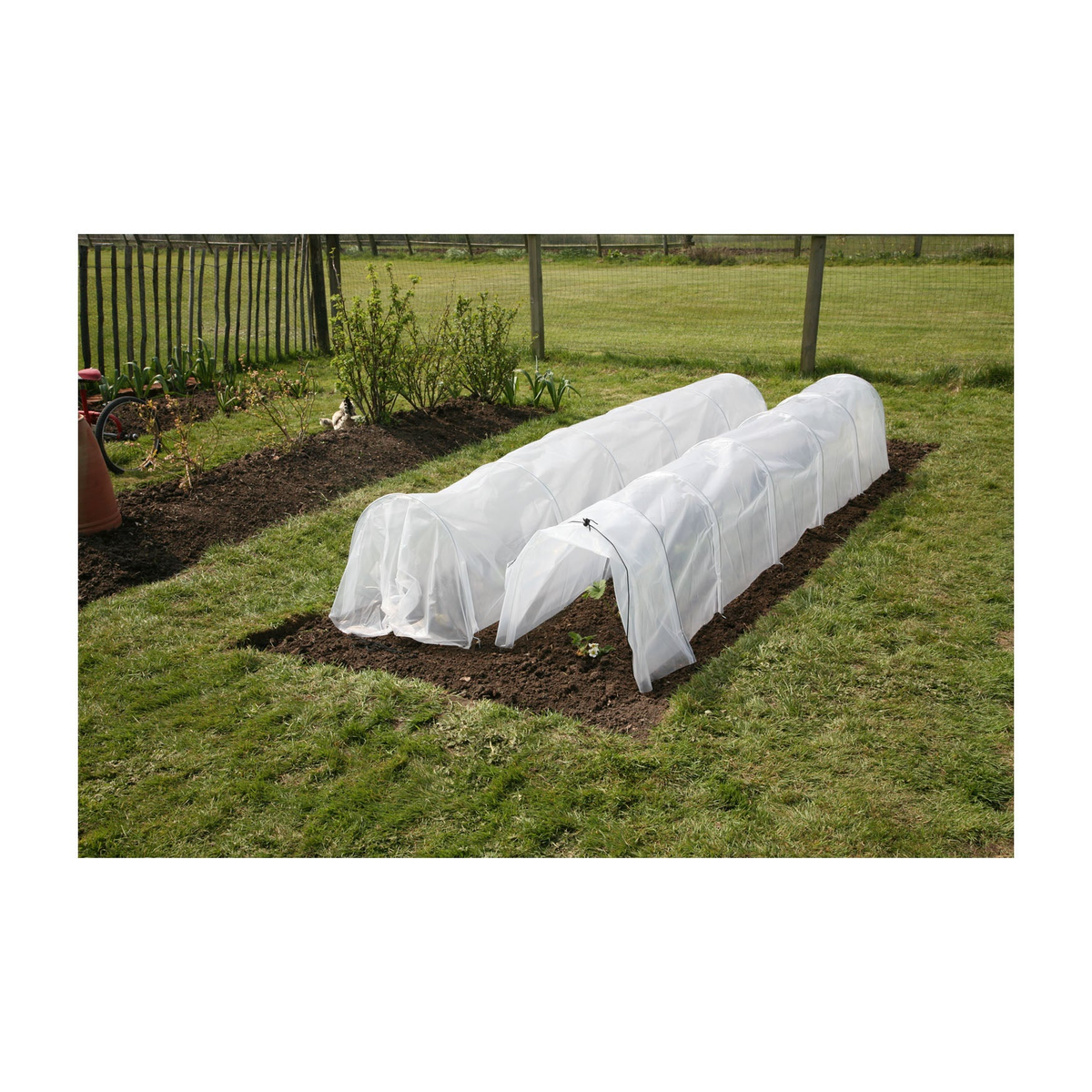 Giant Easy Poly Garden Tunnel in use on a lawn garden, measuring 118&quot;L x 24&quot;W x 18&quot;H, made with UV-stabilized polyethylene and galvanized steel hoops.