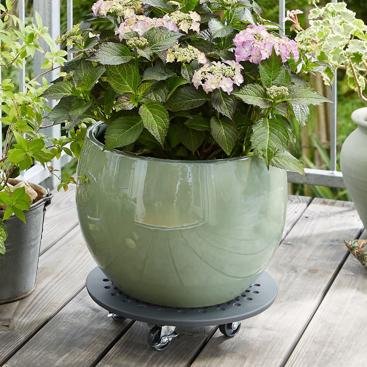 13.4&quot; charcoal round stone plant caddy with brakes featuring a matte gray finish and twin wheel casters for indoor and outdoor use.