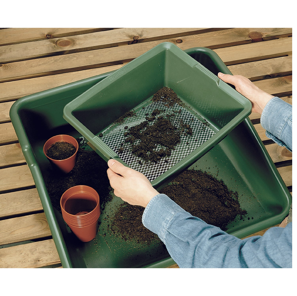 Fine Mesh Garden Sieve in use, sifting soil and compost, durable plastic with galvanized wire mesh.