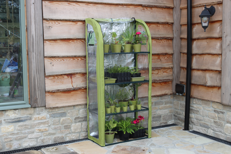 Single Light-Booster Plant House with reflective backing and full-height zippers, nurturing potted plants and seedlings.