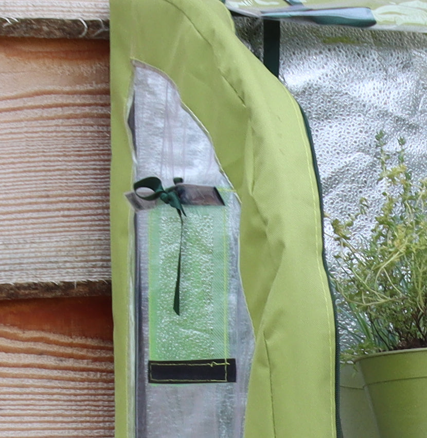 Light-Booster Coldframe with reflective backing and roll-up panel for easy plant access.