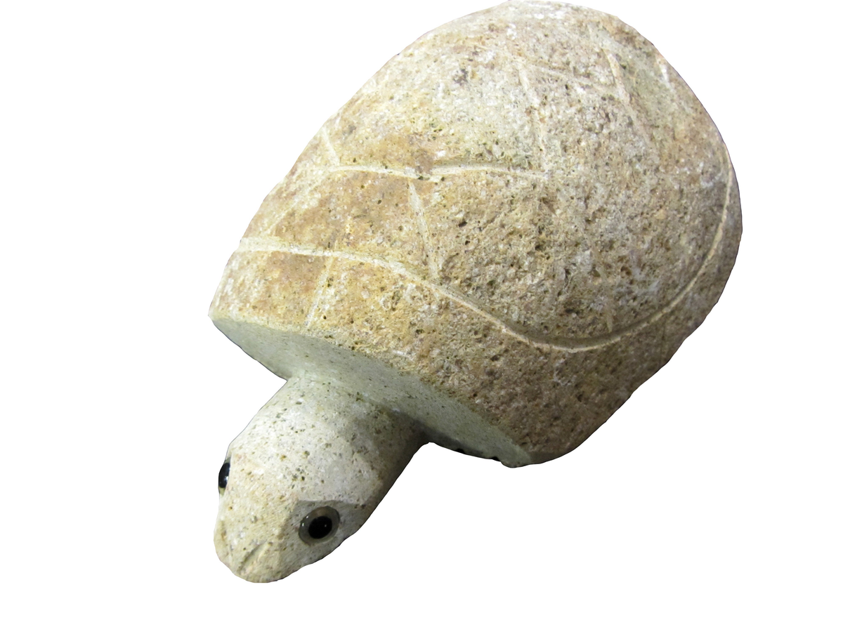 Hand carved granite turtle sculpture with smooth shell and inlaid eyes, 10-inch length.