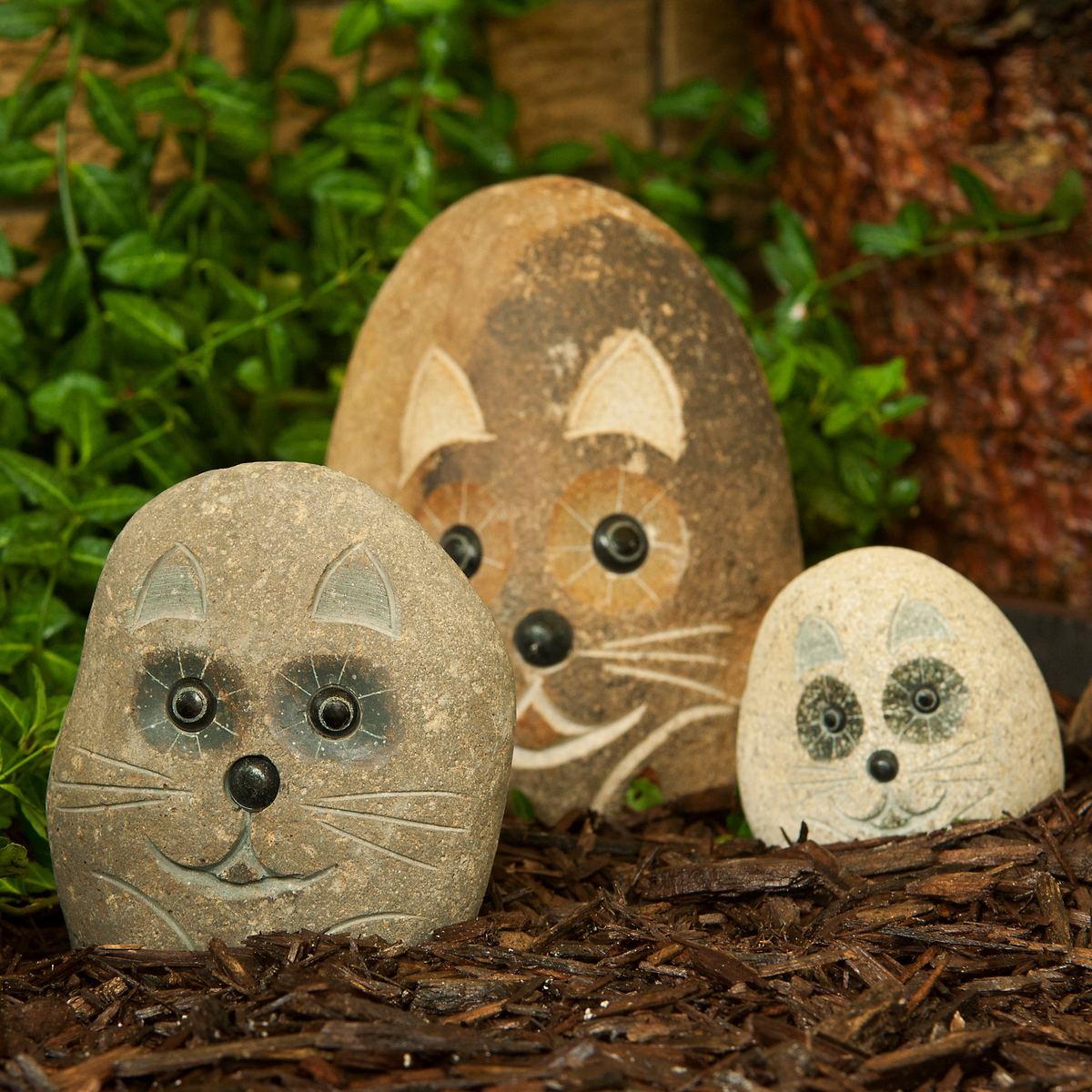 Hand-carved granite stone cat statues in a garden setting, featuring 4&quot;, 6&quot;, and 8&quot; sizes.