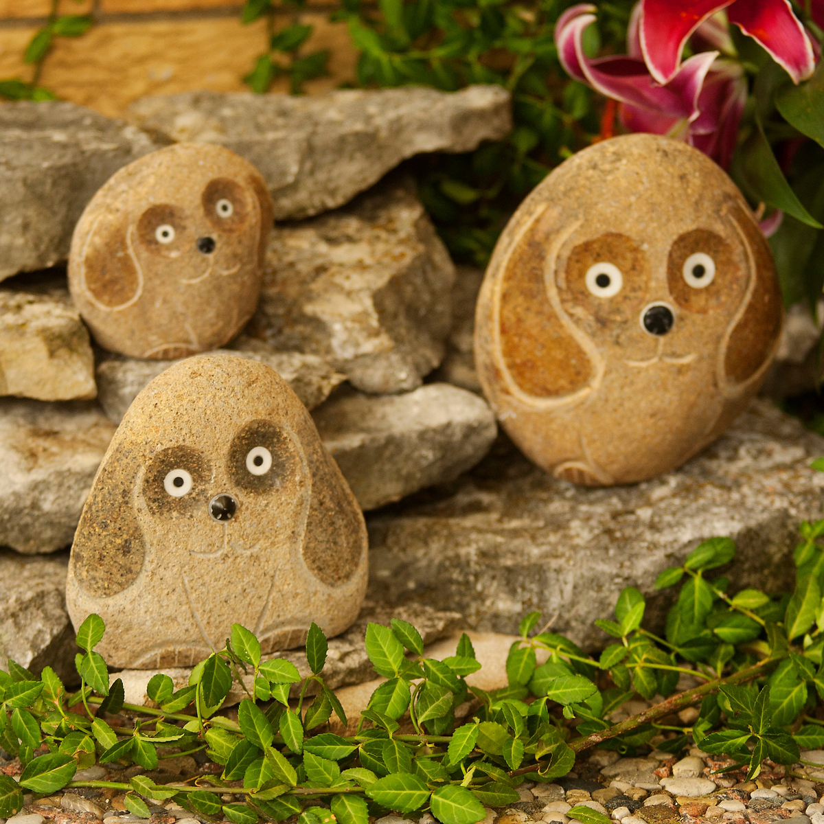 Hand-carved natural granite boulder stone dog sculptures in 3 sizes, part of the Stone Animal Collection.