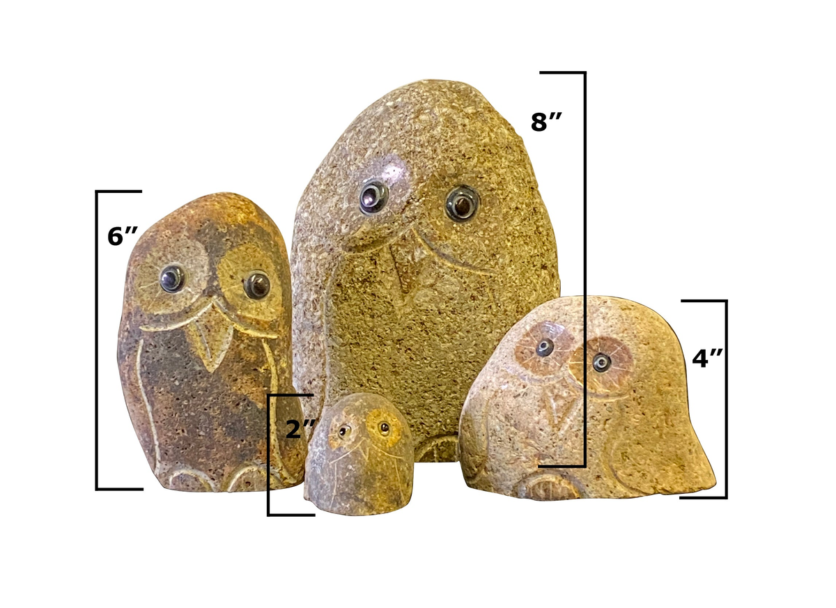 Family of hand-carved natural granite boulder stone owls, set of four with varying sizes.