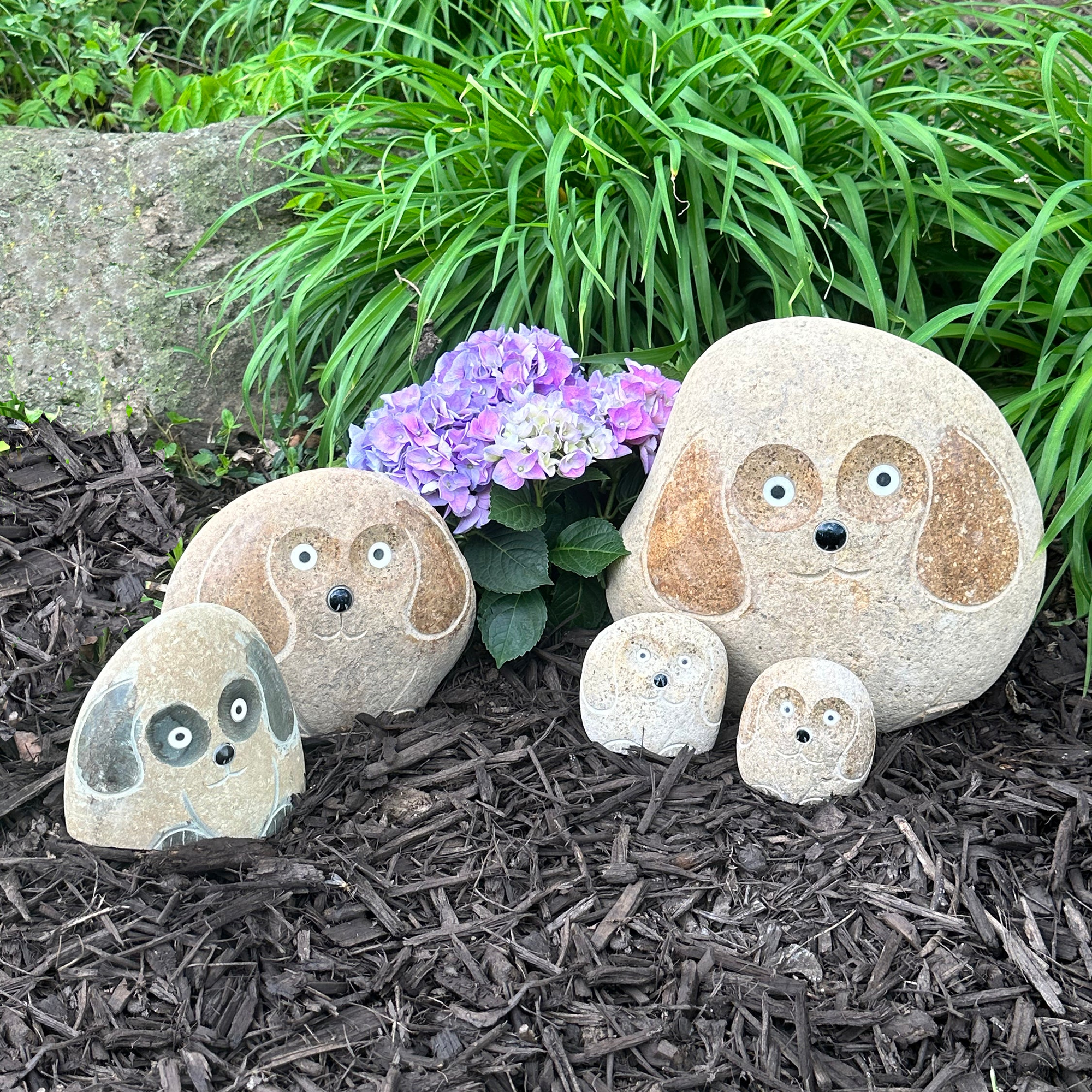 Family of hand-carved natural granite boulder stone dogs in garden setting, 5 pieces, eco-friendly decoration.