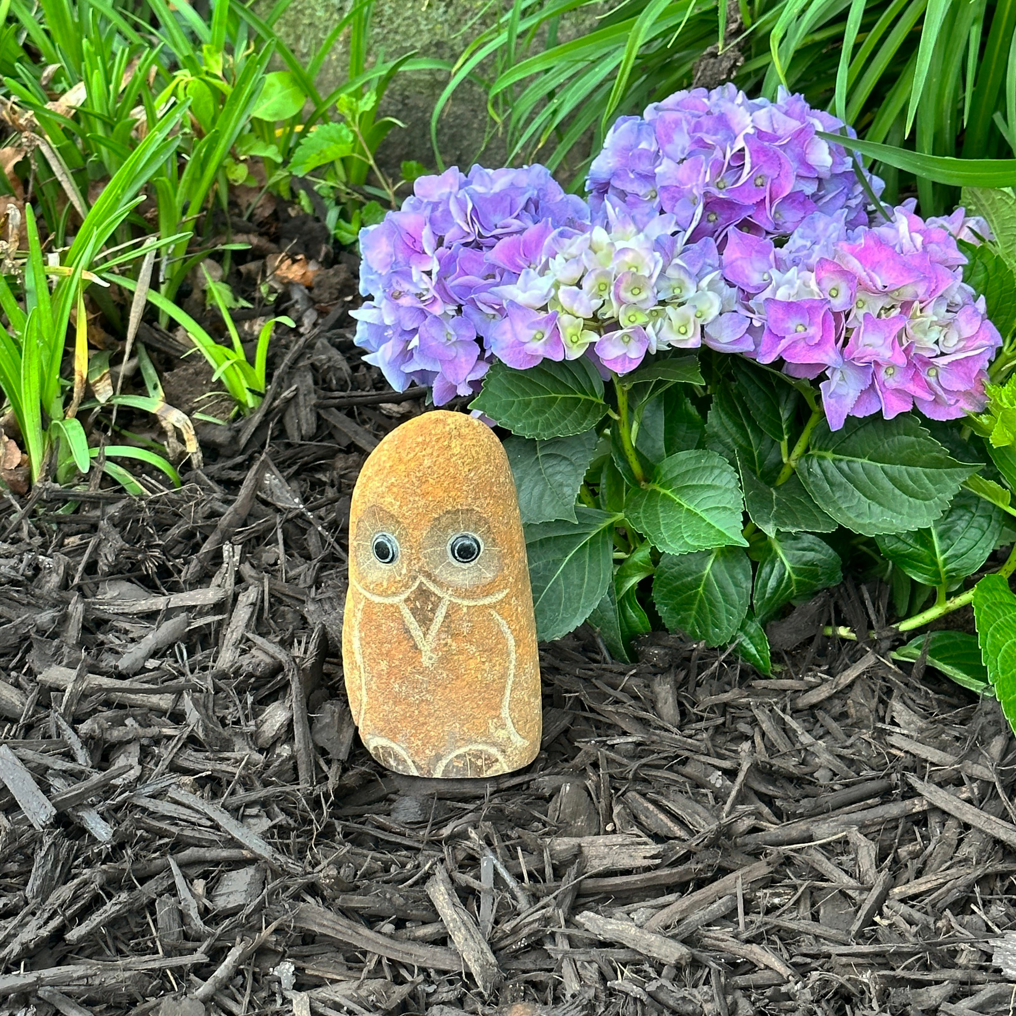 Hand carved natural granite 6-inch owl statue in garden.