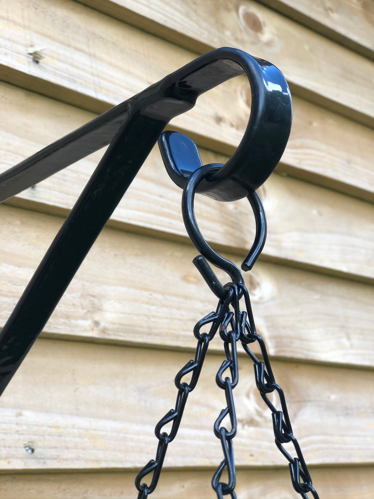 Multipurpose outdoor metal wall hook for garden decor, ideal for hanging baskets and bird feeders.