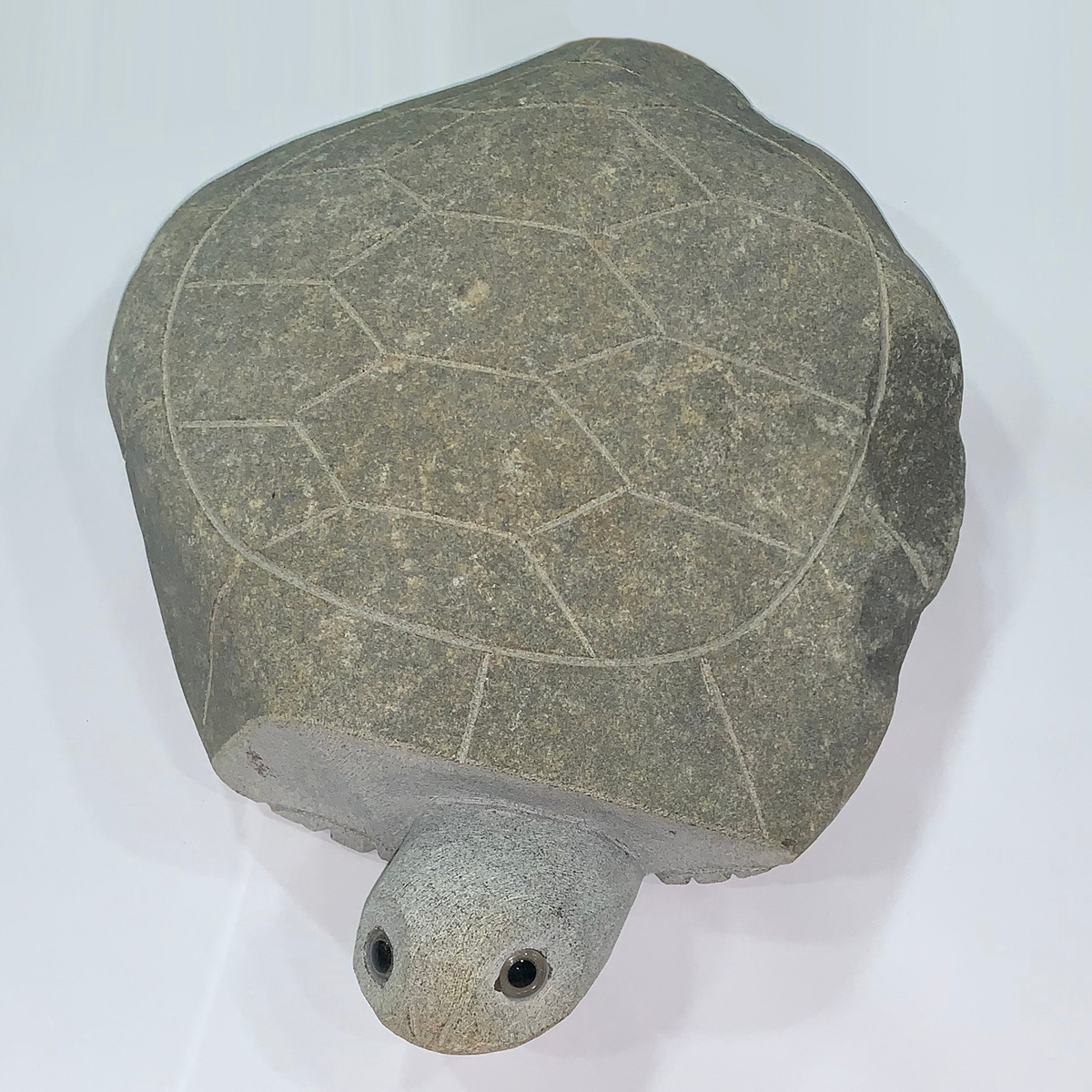 Hand carved natural granite turtle sculpture, 14 inches long, with smooth shell and inlaid eyes.